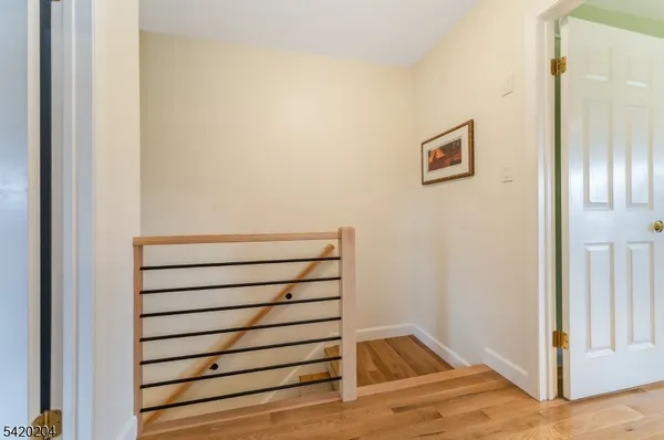 a view of wooden floor and windows in a kitchen