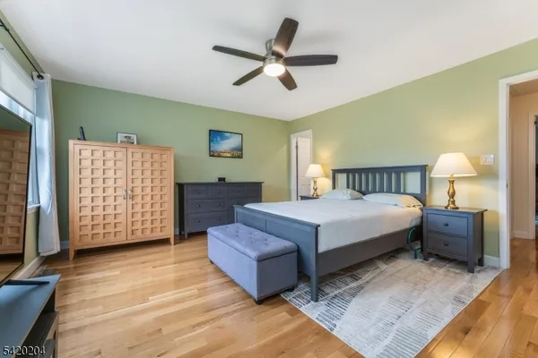 a spacious bedroom with a bed and a dresser