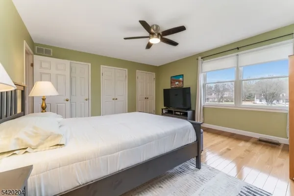 a bedroom with a large bed and a window