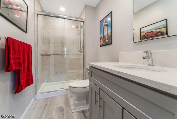 a bathroom with a sink a toilet and shower