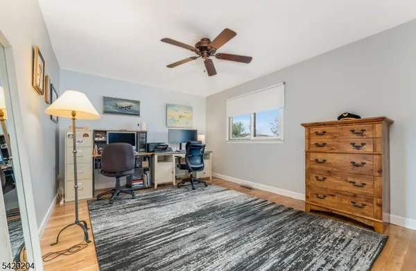 a view of a workspace with furniture and a window