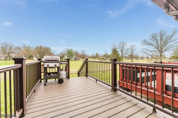 a view of roof deck with a barbeque and wooden stairs