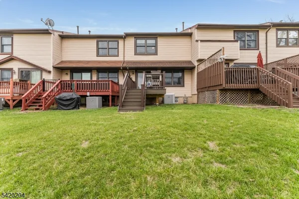 a view of a house with a yard and sitting area