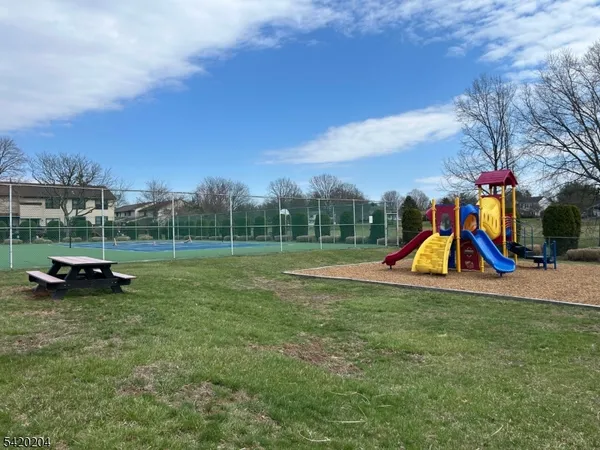 a view of outdoor space with playground and green space