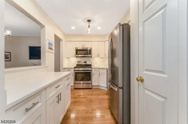 a kitchen with stainless steel appliances a refrigerator sink and stove