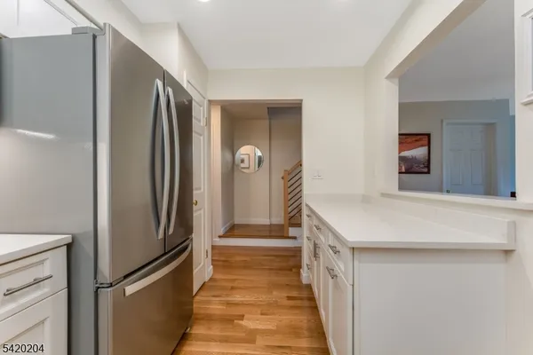 a kitchen with stainless steel appliances a refrigerator and a stove