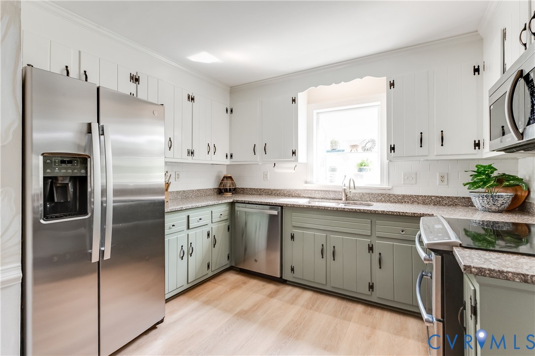 1318 Unison Drive Midlothian, VA 23113 - Photo 16 of 47 a kitchen with stainless steel appliances granite countertop a refrigerator a sink a stove and white cabinets
