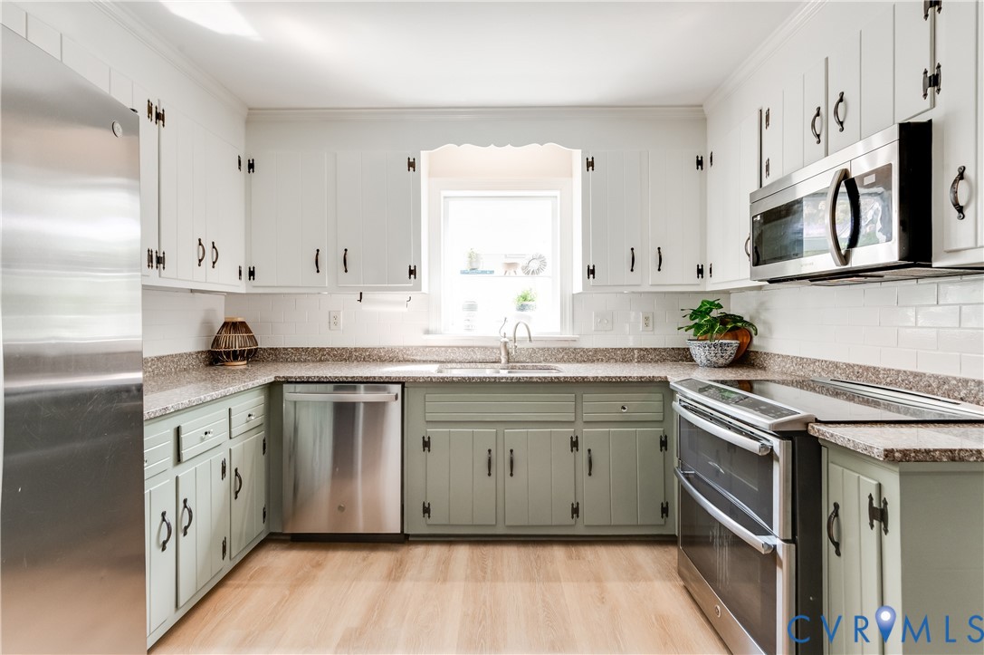1318 Unison Drive Midlothian, VA 23113 - Photo 17 of 47 a kitchen with stainless steel appliances granite countertop a stove a sink dishwasher and a refrigerator
