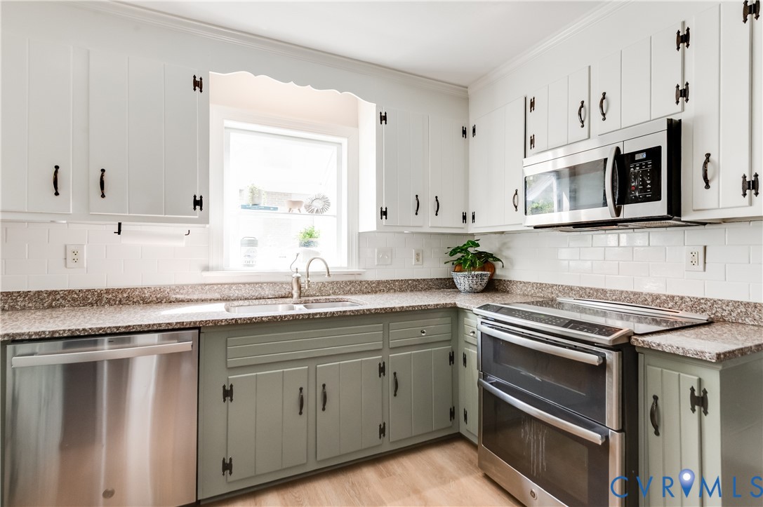 1318 Unison Drive Midlothian, VA 23113 - Photo 18 of 47 a kitchen with stainless steel appliances granite countertop a sink and cabinets