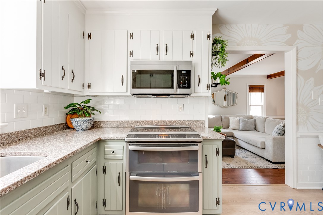 1318 Unison Drive Midlothian, VA 23113 - Photo 20 of 47 a kitchen with stainless steel appliances granite countertop a stove a sink and a microwave