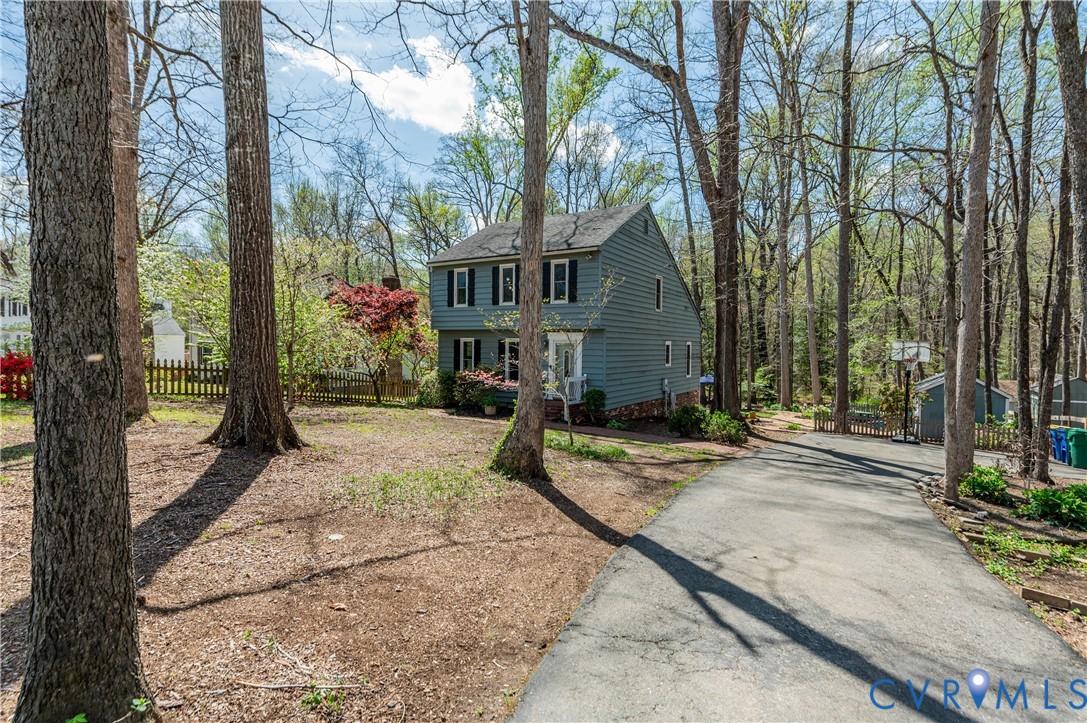 1318 Unison Drive Midlothian, VA 23113 - Photo 2 of 47 a view of a house with trees in the background