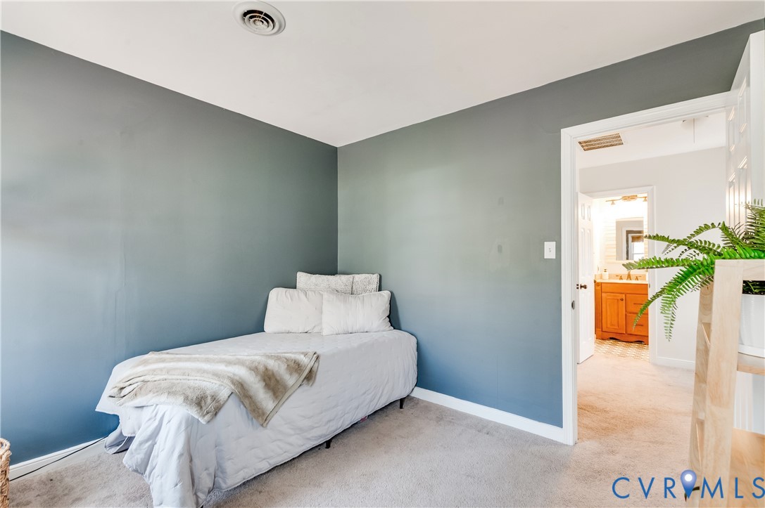 1318 Unison Drive Midlothian, VA 23113 - Photo 32 of 47 a bedroom with a bed and a table