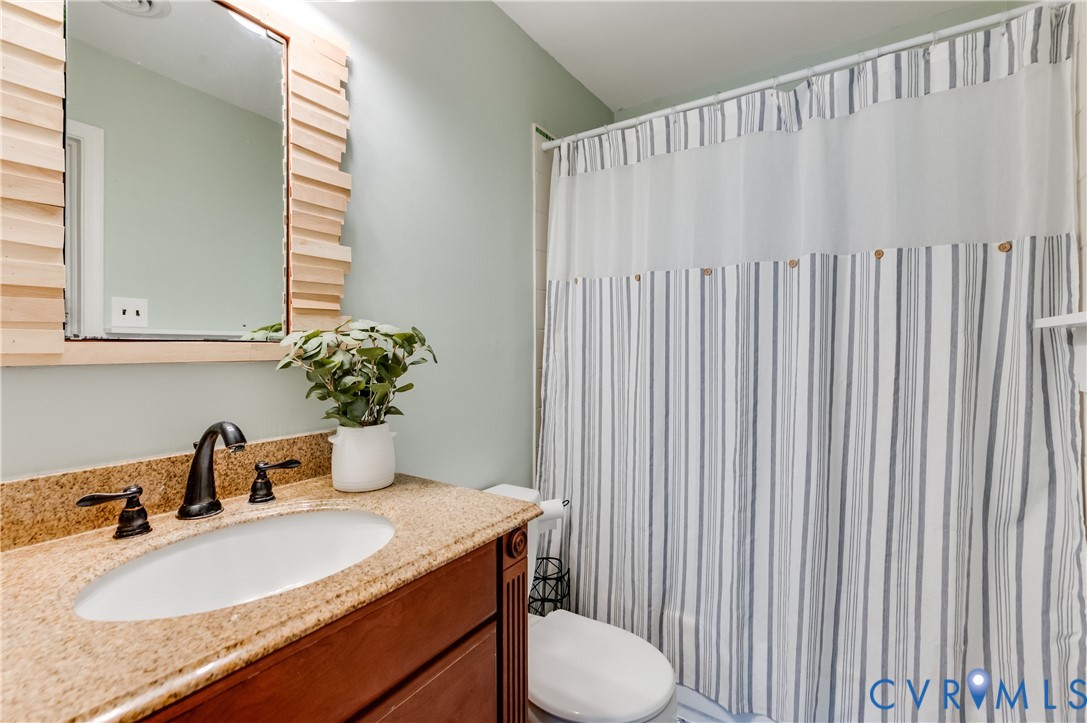 1318 Unison Drive Midlothian, VA 23113 - Photo 35 of 47 a bathroom with a granite countertop sink and a mirror with toilet