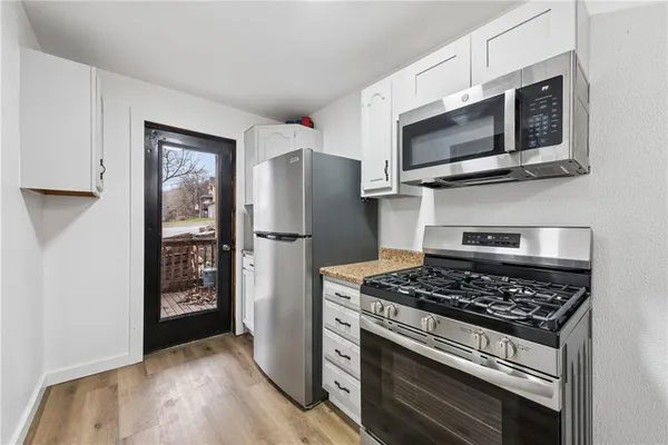 a kitchen with a refrigerator stove and microwave