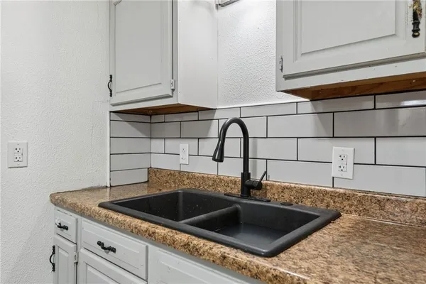a kitchen with a sink and cabinets