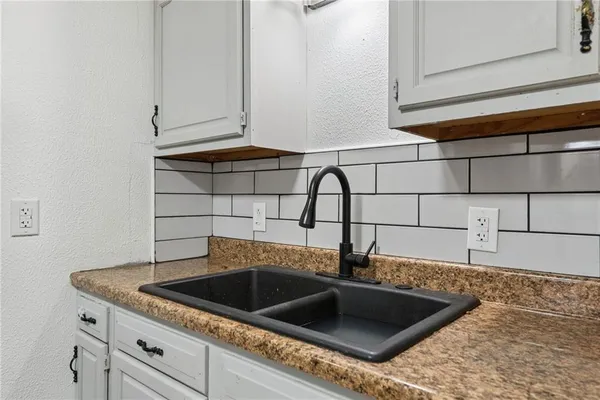 a kitchen with a sink and cabinets