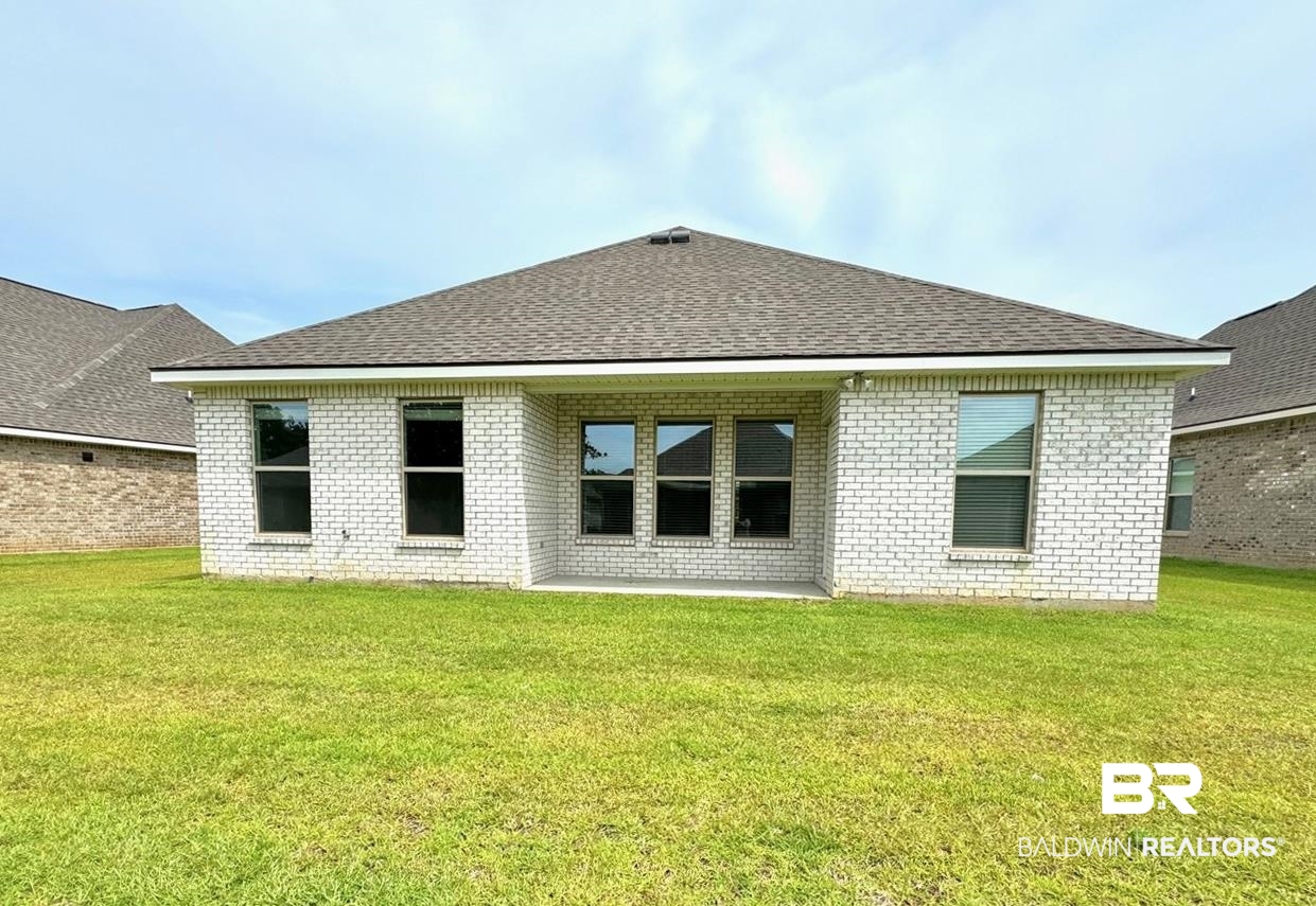 904 Sumter Loop Foley, AL 36535 - Photo 8 of 10 Back of property with a yard and a patio area