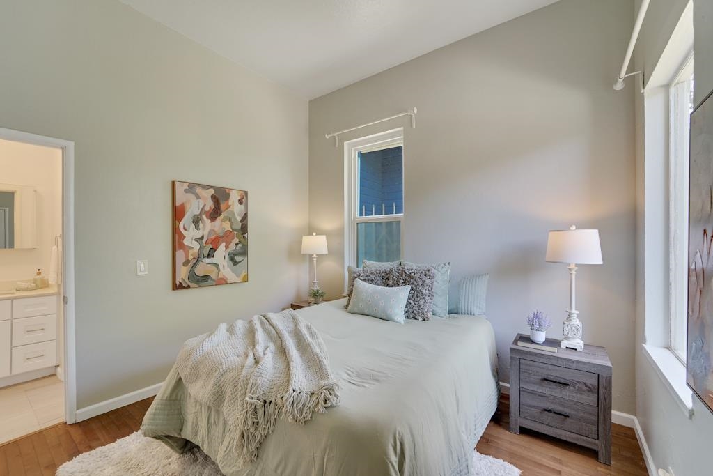 1022 Chestnut Street Oakland, CA 94607 - Photo 22 of 60 a bedroom with a bed and a lamp on dresser