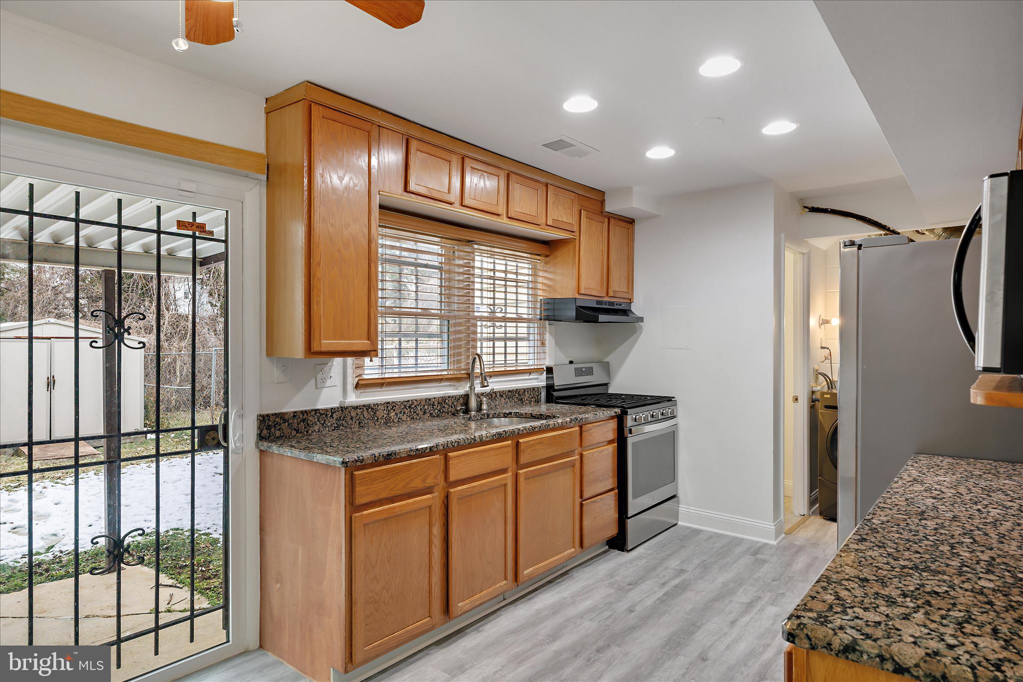 5600 Walker Mill Road Capitol Heights, MD 20743 - Photo 11 of 30 a kitchen with stainless steel appliances granite countertop a stove a sink and a refrigerator