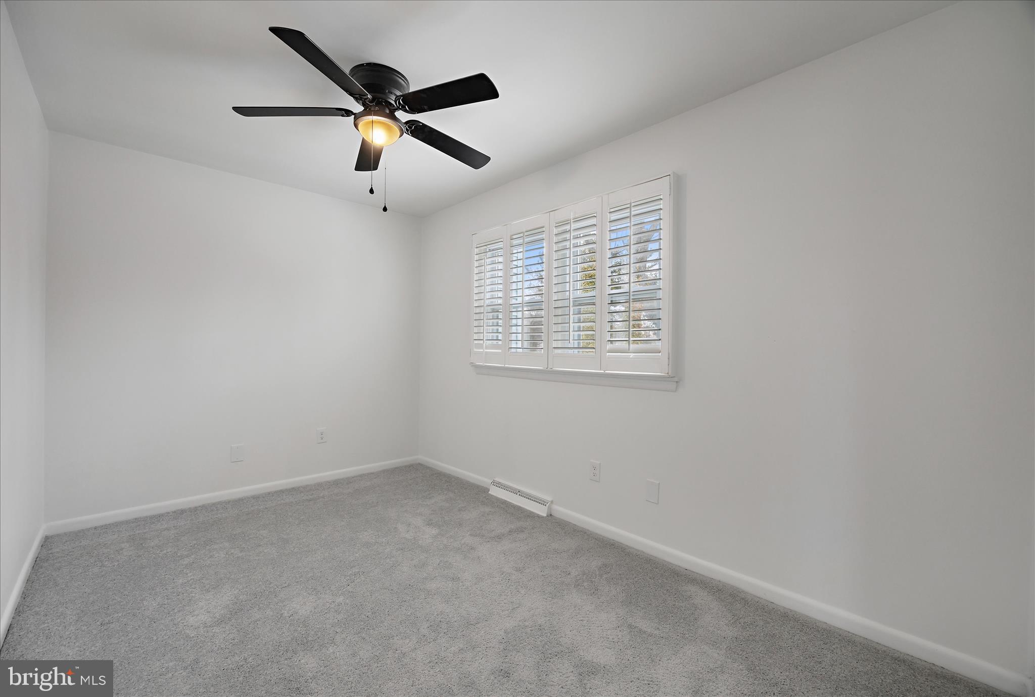 5600 Walker Mill Road Capitol Heights, MD 20743 - Photo 16 of 30 an empty room with ceiling fan and window