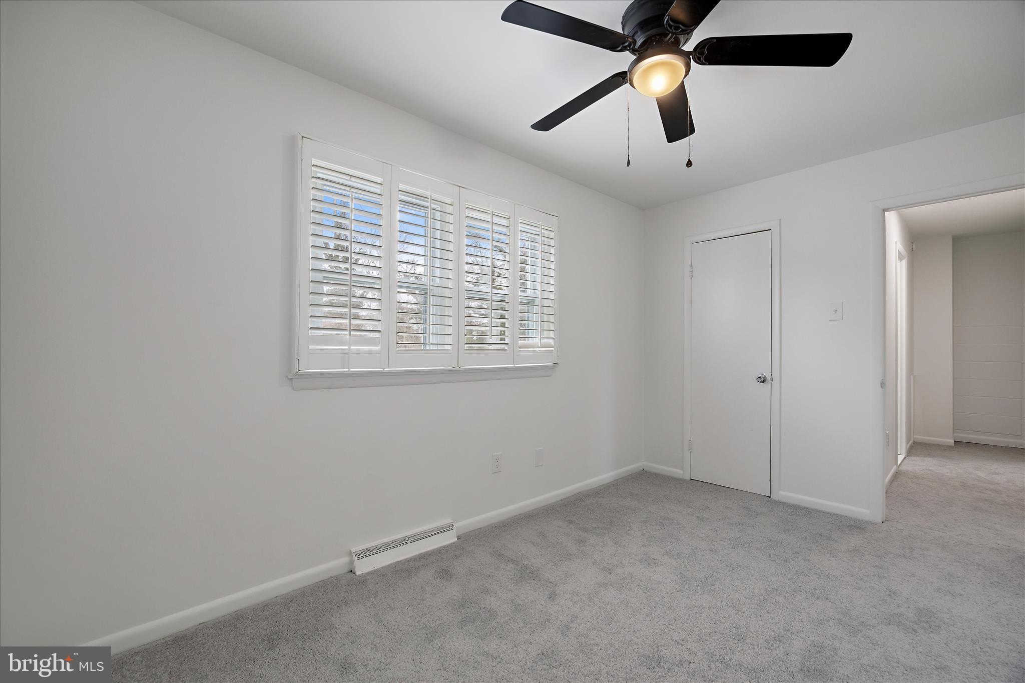 5600 Walker Mill Road Capitol Heights, MD 20743 - Photo 17 of 30 en empty room with ceiling fan and window
