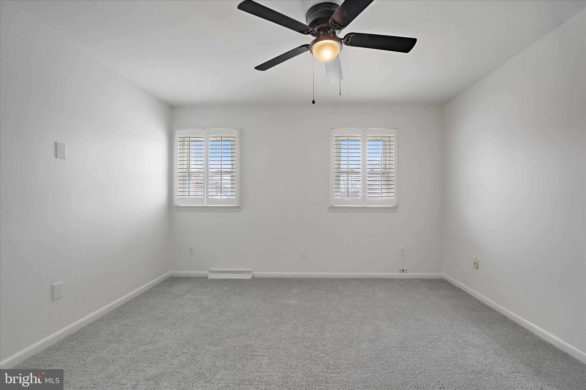 5600 Walker Mill Road Capitol Heights, MD 20743 - Photo 20 of 30 an empty room with windows and ceiling fan
