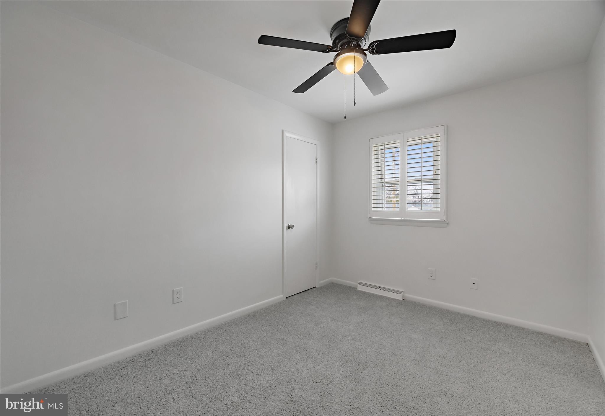 5600 Walker Mill Road Capitol Heights, MD 20743 - Photo 22 of 30 an empty room with a window and a fan