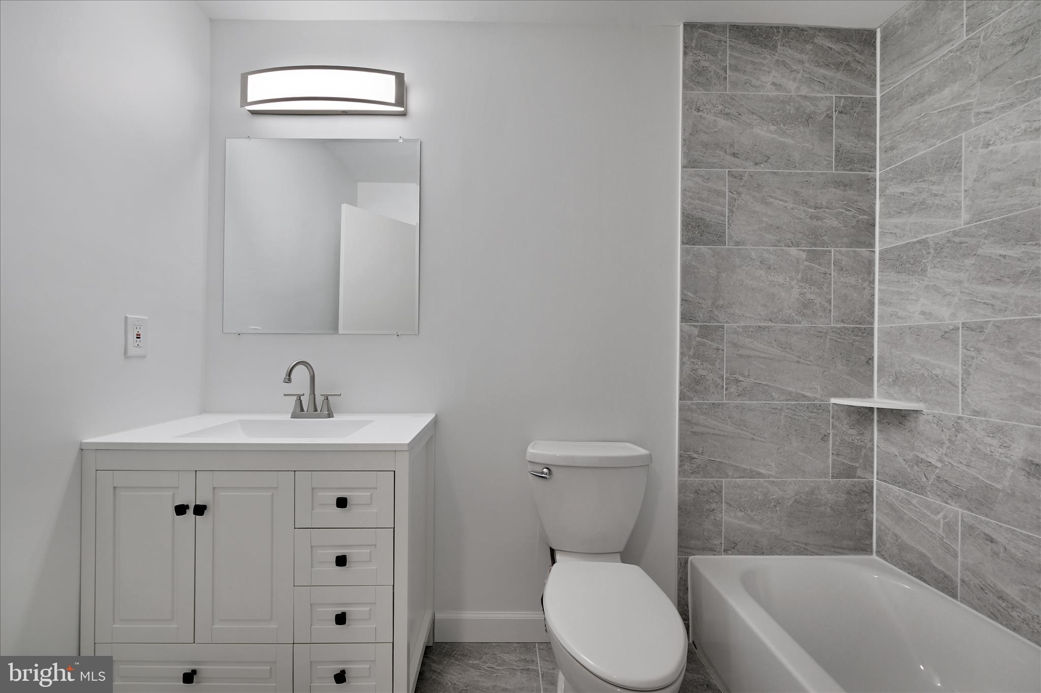 5600 Walker Mill Road Capitol Heights, MD 20743 - Photo 24 of 30 a bathroom with a toilet a sink and bathtub