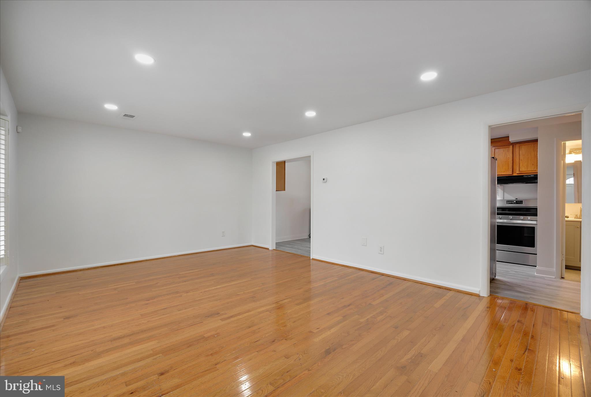 5600 Walker Mill Road Capitol Heights, MD 20743 - Photo 3 of 30 an empty room with wooden floor closet and windows