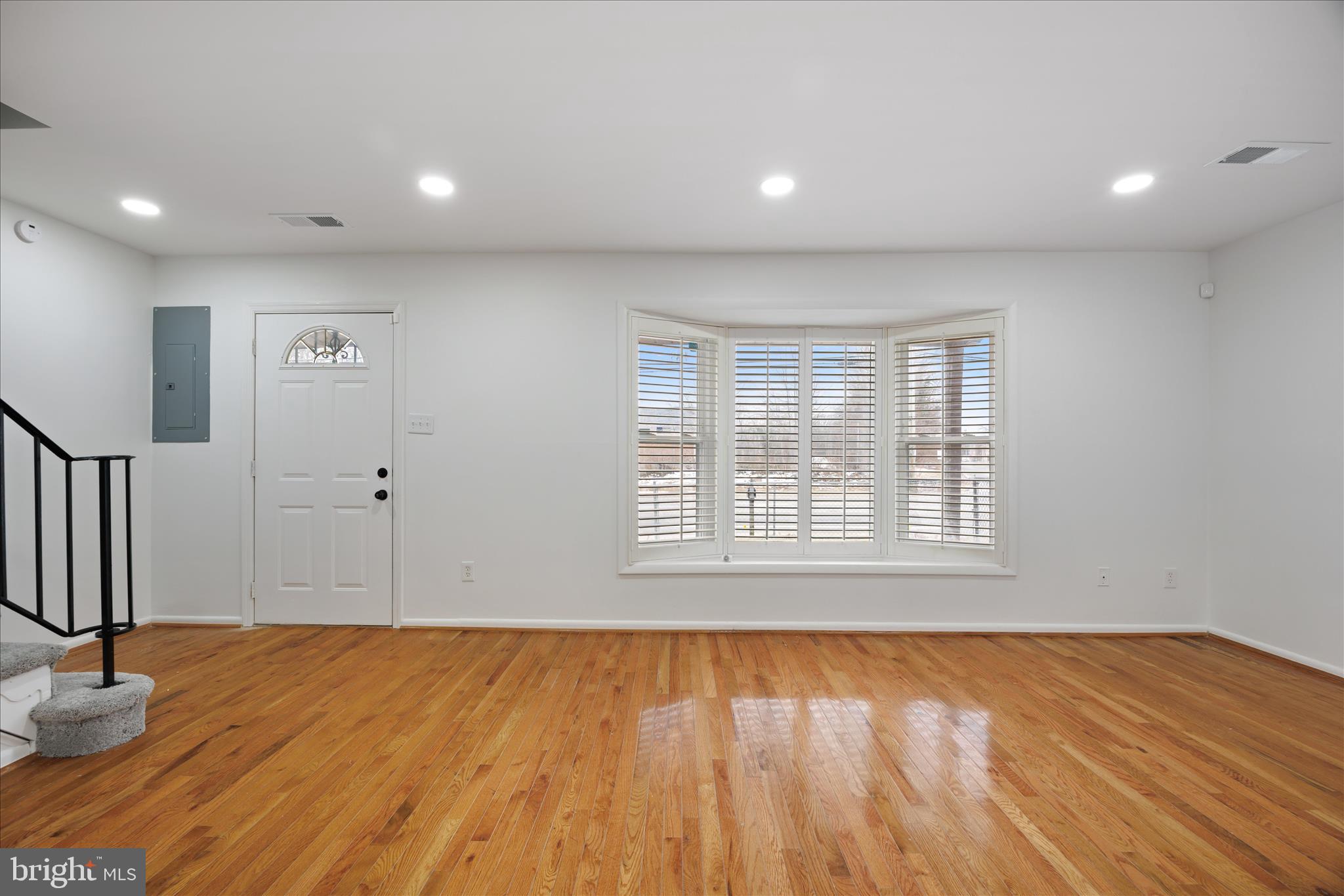 5600 Walker Mill Road Capitol Heights, MD 20743 - Photo 6 of 30 a view of an empty room with wooden floor and a window