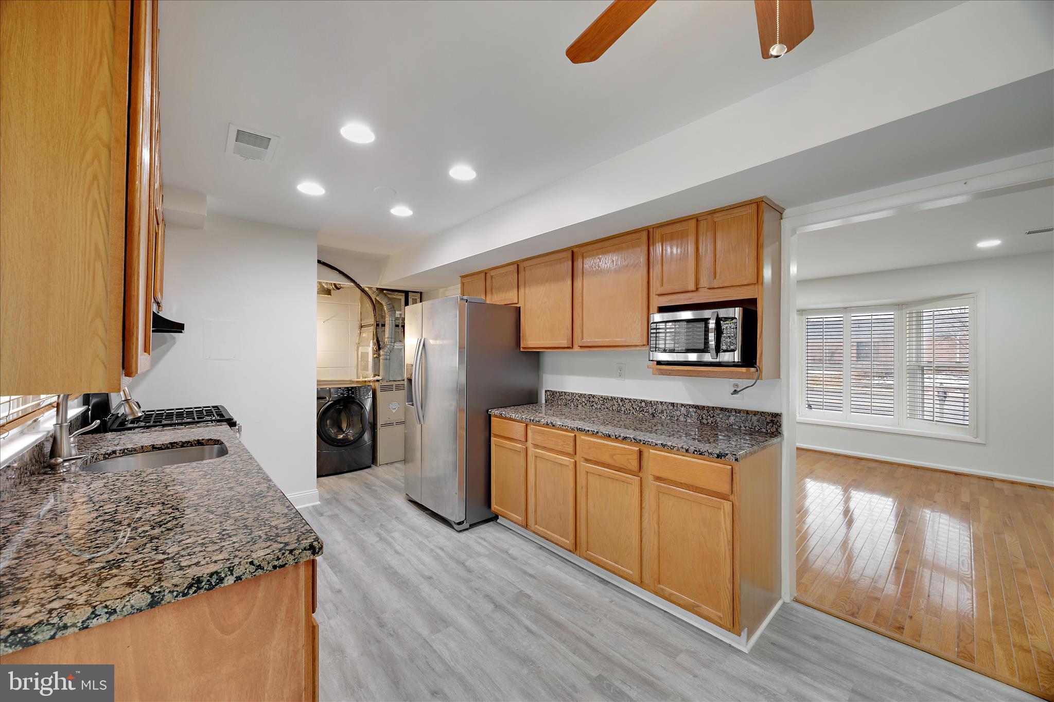 5600 Walker Mill Road Capitol Heights, MD 20743 - Photo 9 of 30 a kitchen with stainless steel appliances granite countertop a sink stove and refrigerator