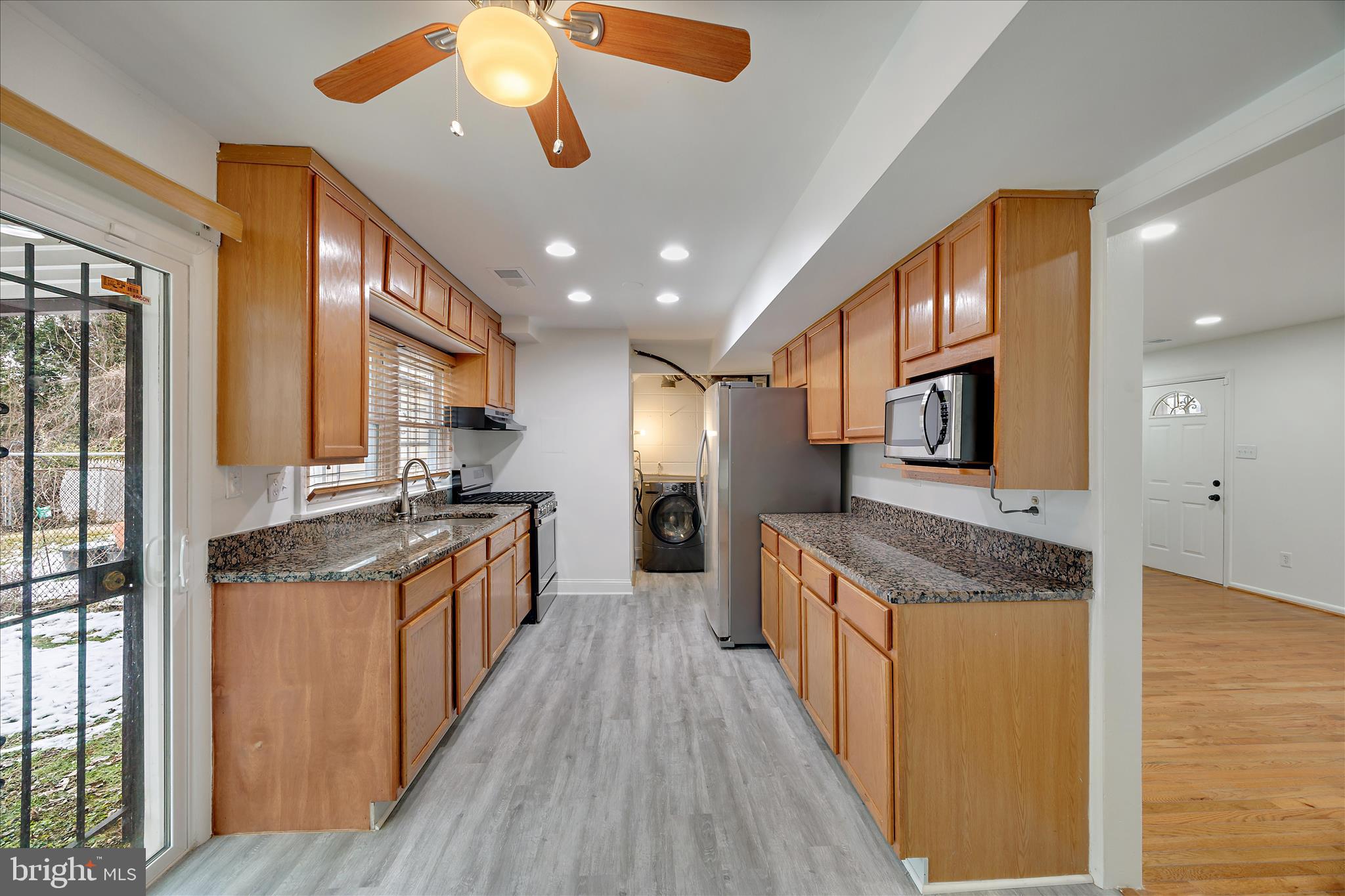 5600 Walker Mill Road Capitol Heights, MD 20743 - Photo 10 of 30 a large kitchen with stainless steel appliances granite countertop a lot of counter space and wooden floor