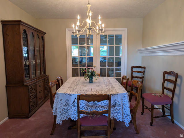 1411 Millbrook Way Bountiful, UT 84010 - Photo 12 of 36 Dining area featuring a central chandelier, light-colored walls, and a decorative chair rail molding