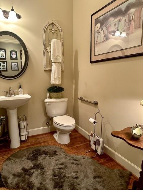 104 Willow Overlook Canton, GA 30115 - Photo 16 of 27 a bathroom with a toilet a sink and mirror