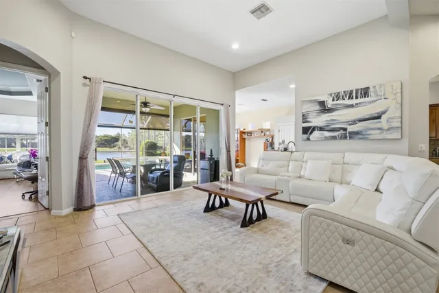 a living room with furniture and a view of kitchen