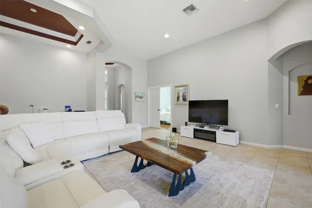 a living room with furniture and a chandelier