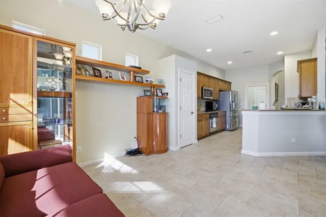 a living room with furniture and a chandelier