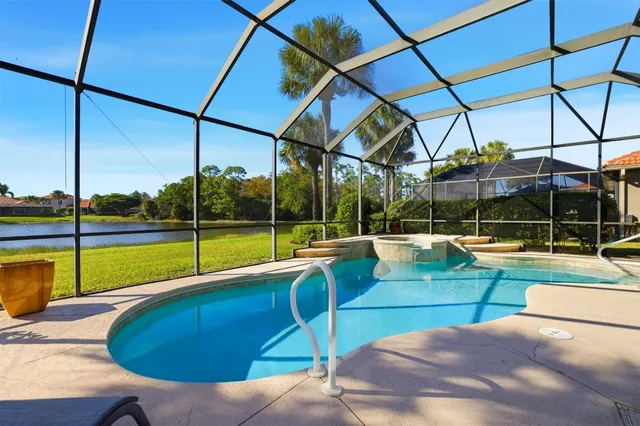 a view of a swimming pool with a lawn chairs under an umbrella