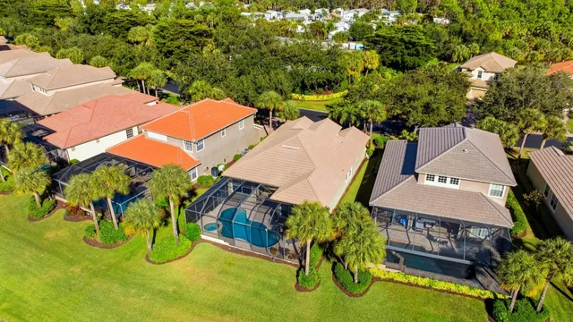 an aerial view of a house with swimming pool and garden