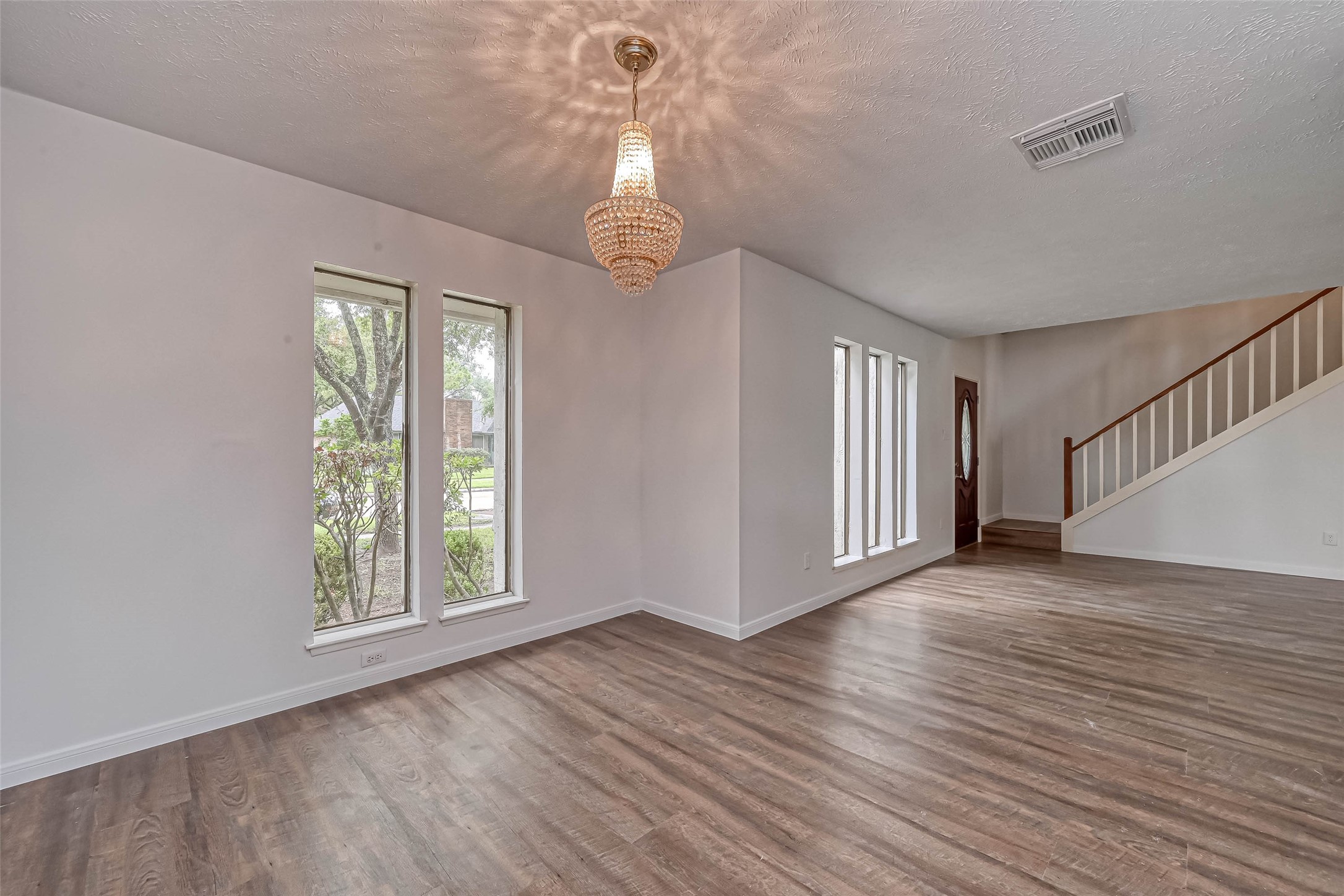 2831 Pecan Ridge Drive Sugar Land, TX 77479 - Photo 14 of 44 a view of an empty room with wooden floor and a window