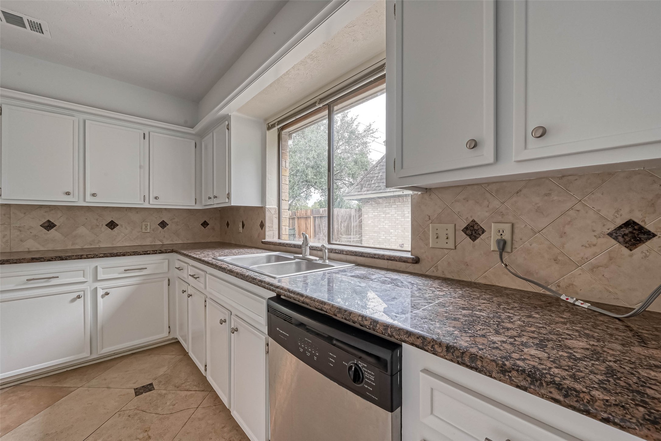 2831 Pecan Ridge Drive Sugar Land, TX 77479 - Photo 16 of 44 a kitchen with granite countertop white cabinets and white appliances
