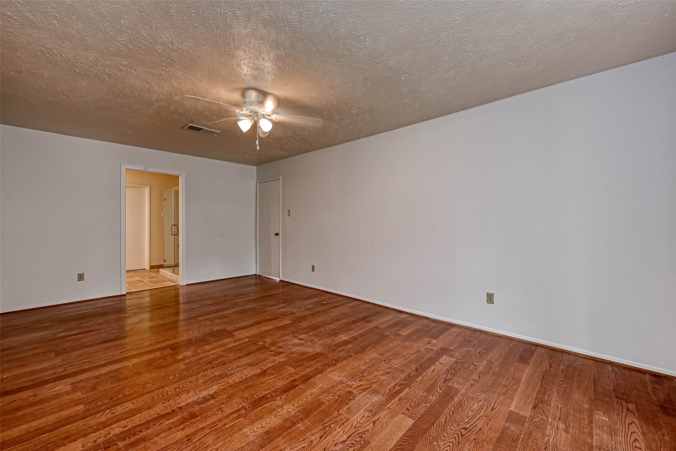 2831 Pecan Ridge Drive Sugar Land, TX 77479 - Photo 25 of 44 a view of empty room with wooden floor and fan