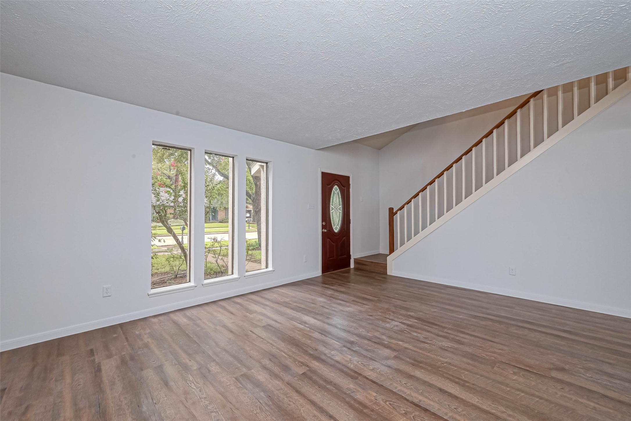 2831 Pecan Ridge Drive Sugar Land, TX 77479 - Photo 6 of 44 a view of an empty room with wooden floor and a window