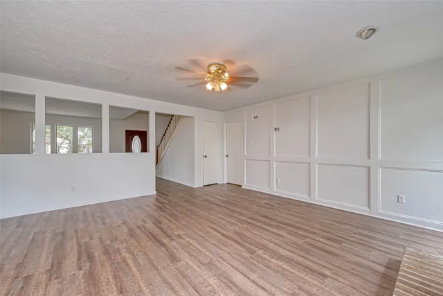 a view of a livingroom with a furniture wooden floor and a kitchen