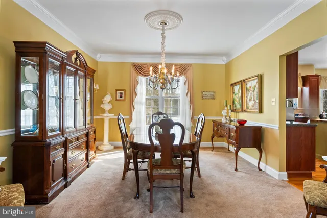 a living room with furniture a chandelier and a window