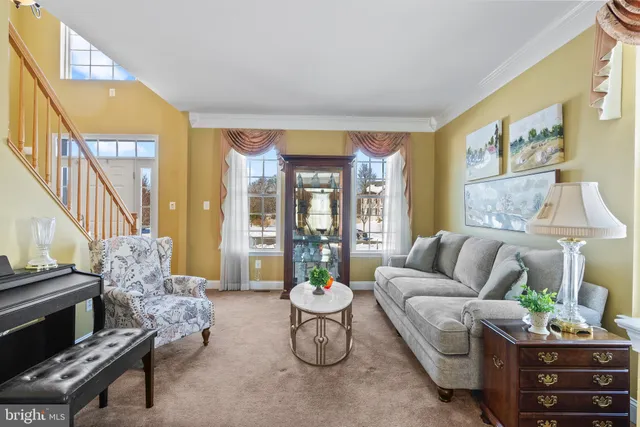 a kitchen with stainless steel appliances granite countertop a stove top oven a refrigerator a dining table and chairs with wooden floor