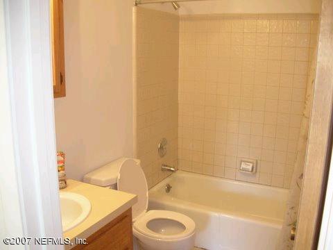1150 Penman Road Jacksonville Beach, FL 32250 - Photo 16 of 16 a bathroom with a granite countertop sink and a bathtub