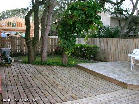 1150 Penman Road Jacksonville Beach, FL 32250 - Photo 3 of 16 a view of a backyard with wooden fence and plants