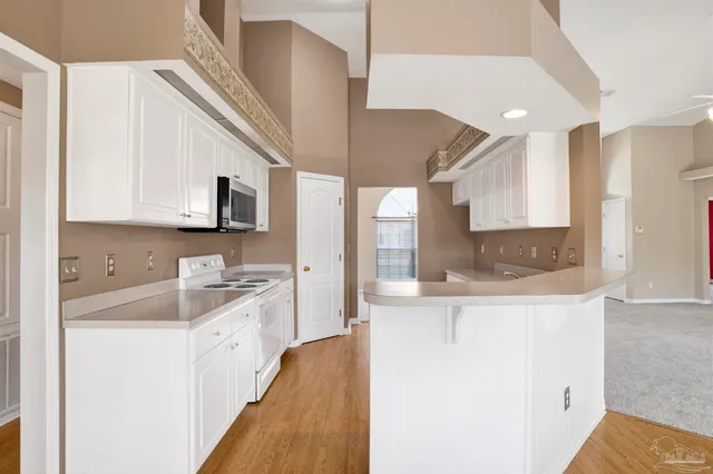 a kitchen with stainless steel appliances granite countertop a sink stove and microwave