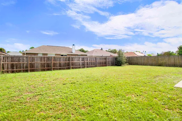 a view of a garden with a building in the background